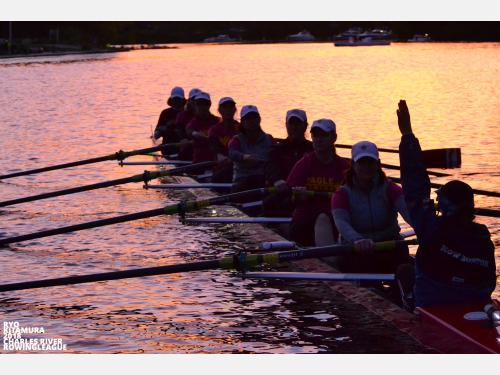 Image of Youth Learn to Row Program participants rowing in the sunset.