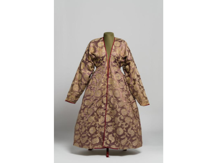 A purple robe with long sleeves and yellow floral motifs.